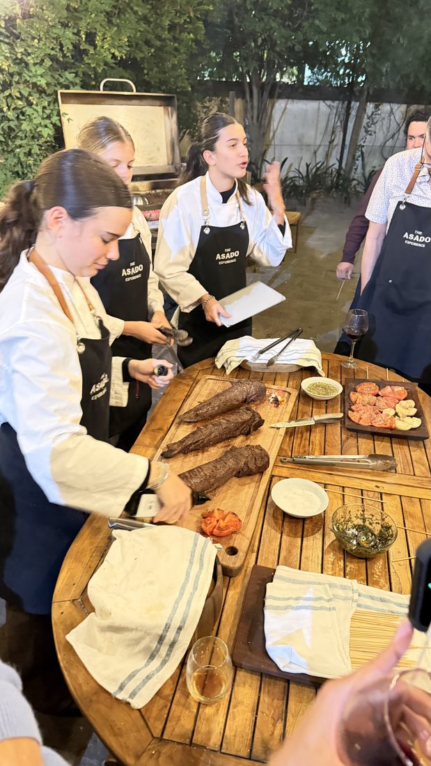 The asado team plating at a long table