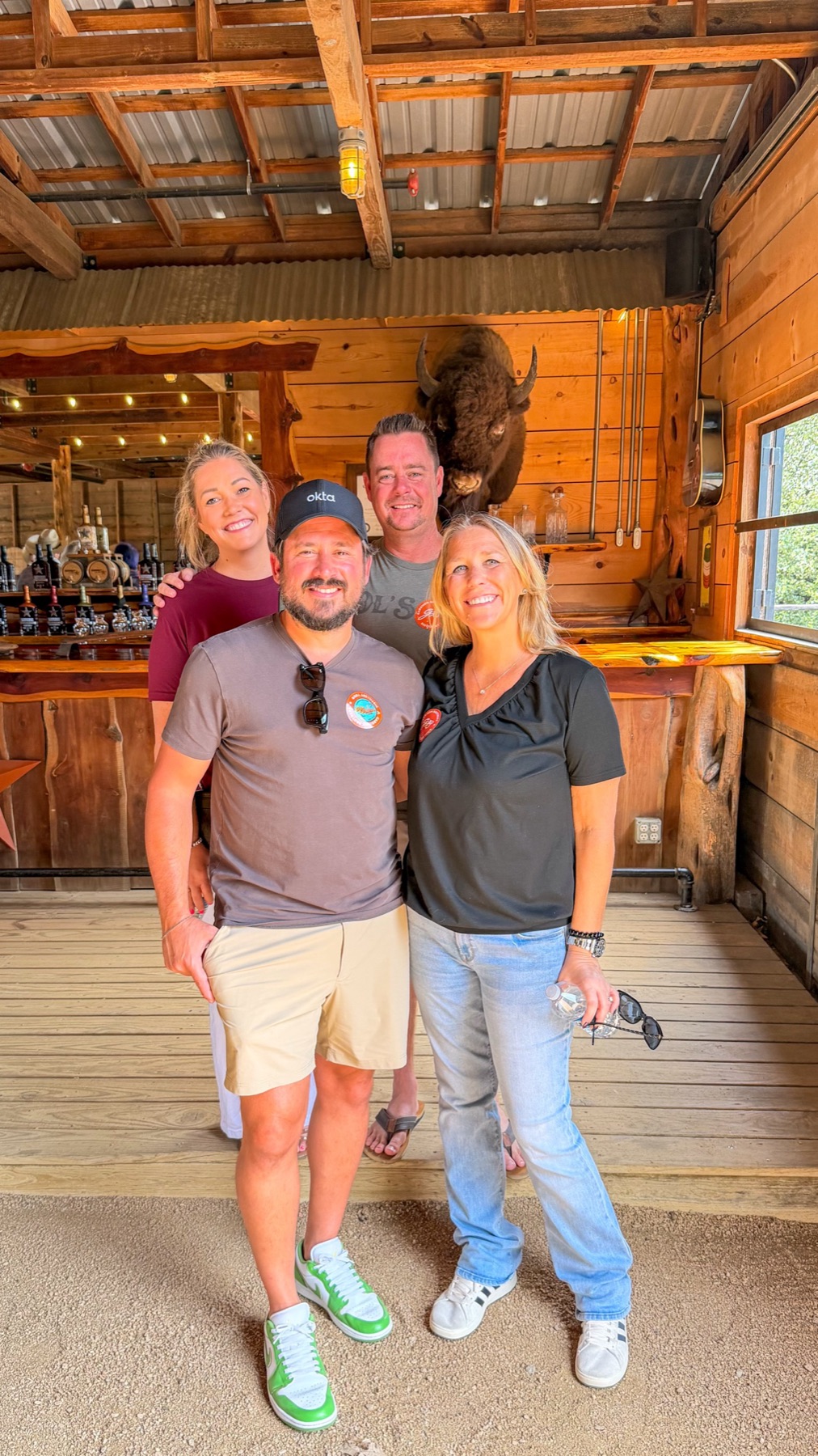 The four of them at the Garrison Brothers tasting bar beneath a mounted bison head
