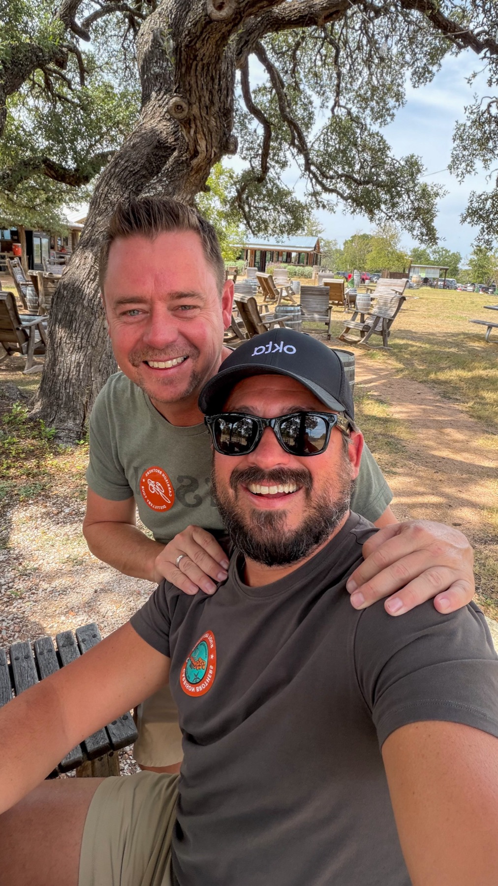 Selfie of Matt and Billy under a live oak, both wearing Garrison tour stickers