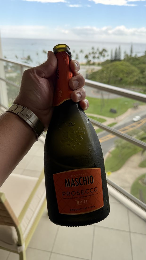A sparkling bottle on the balcony above the ocean