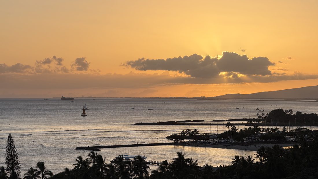 A golden sunset over the water from the lanai
