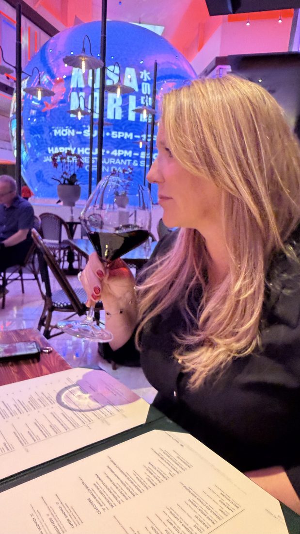 A long, dim, neon-lit dinner