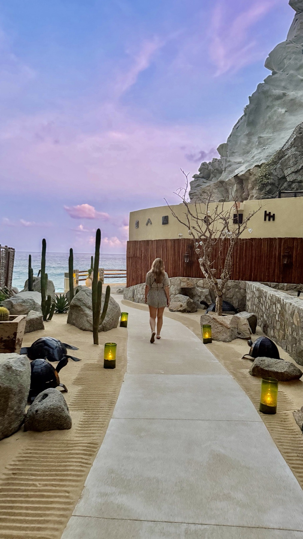 A path up the cliff lit by candles at dusk