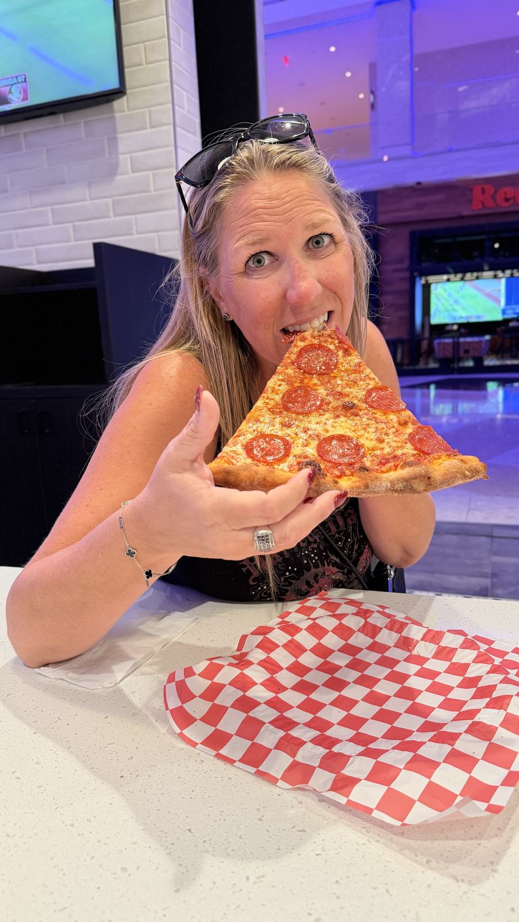 Amber holding an enormous slice of pepperoni pizza